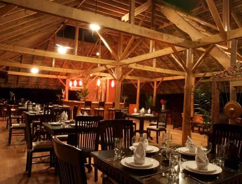 A restaurant with wooden tables and chairs.