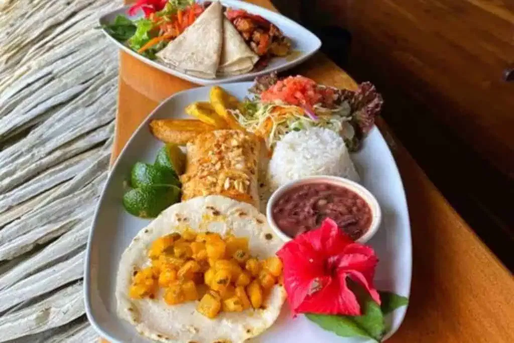 A plate of food on a wooden table.