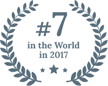 A laurel wreath design surrounds the text: 